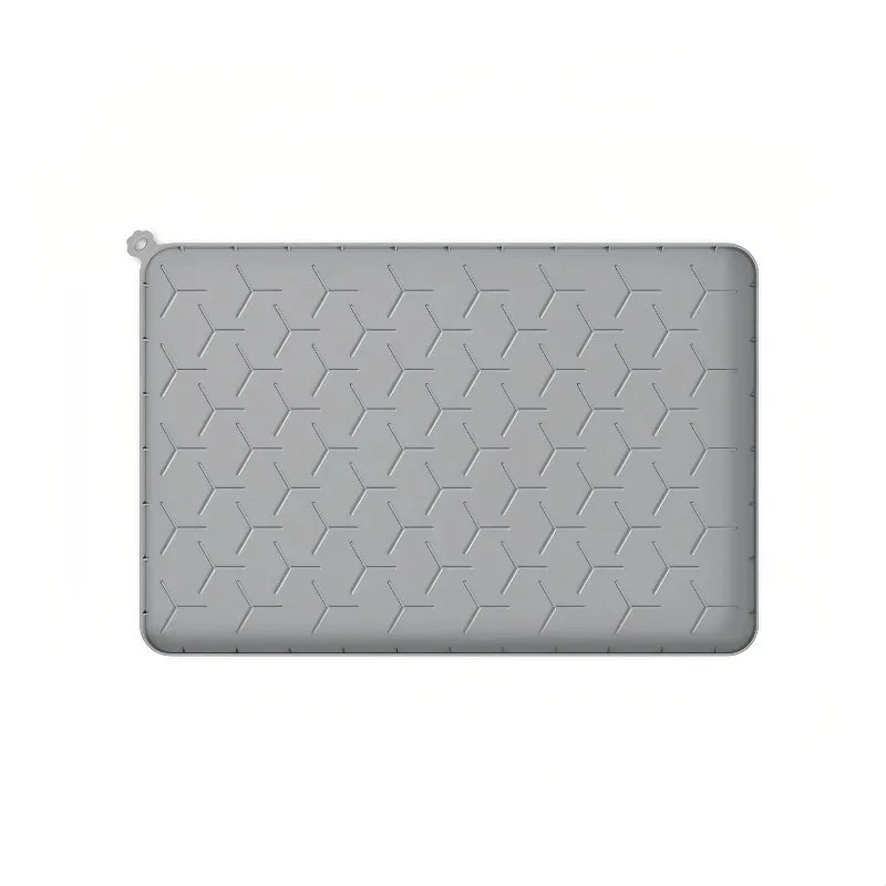 Gray silicone pet feeding mat with raised edges, textured non-slip surface, and hanging hole for easy storage