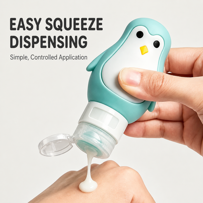 Mint green penguin travel bottle dispensing lotion onto a hand