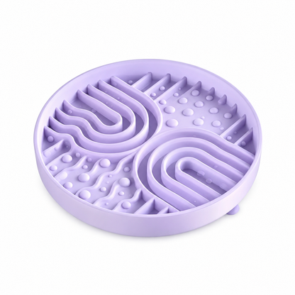 Purple silicone pet slow feeder bowl on white background, featuring raised maze channels and textured bumps to support slower pet feeding.