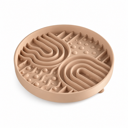Beige silicone pet slow feeder bowl on white background, with raised maze channels and textured bumps to help slow down pet eating.